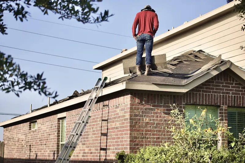Professional roofer working on a residential roof in Raleigh-Ridge Park